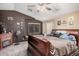 Stylish bedroom featuring an electric fireplace and a ceiling fan, creating a cozy retreat at 38274 N Tumbleweed Ln, San Tan Valley, AZ 85140