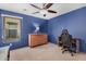 Bedroom with bold blue walls, a ceiling fan, and neutral carpet, creating a calm retreat at 38274 N Tumbleweed Ln, San Tan Valley, AZ 85140