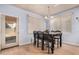 Dining room with a modern chandelier, hardwood floors, and a view to the back yard at 38274 N Tumbleweed Ln, San Tan Valley, AZ 85140