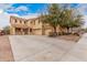 Charming two-story home featuring a three-car garage, mature trees, and a well-maintained, light-colored exterior at 38274 N Tumbleweed Ln, San Tan Valley, AZ 85140