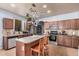 Well-lit kitchen featuring stainless steel appliances, ample counter space, and a convenient pot rack at 38274 N Tumbleweed Ln, San Tan Valley, AZ 85140