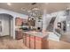 Well-equipped kitchen with stainless steel appliances, island, and hanging pot rack at 38274 N Tumbleweed Ln, San Tan Valley, AZ 85140