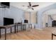 A spacious living room is equipped with a ceiling fan and beautiful hardwood floors at 38274 N Tumbleweed Ln, San Tan Valley, AZ 85140