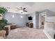 Comfortable living room with a ceiling fan, neutral carpet, tv and access to additional rooms at 38274 N Tumbleweed Ln, San Tan Valley, AZ 85140