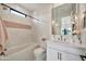 Bright bathroom featuring a shower-tub combo, chevron tile accent, and a modern vanity with pendant lighting at 3964 E Penedes Dr, Gilbert, AZ 85298