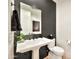 Powder bathroom with a pedestal sink, mirror, and black shiplap accent wall at 3964 E Penedes Dr, Gilbert, AZ 85298