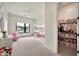 Bedroom with a bunk bed, ceiling fan, window, closet, and pink accents at 3964 E Penedes Dr, Gilbert, AZ 85298