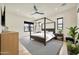 Relaxing bedroom with shiplap accent wall, a ceiling fan, a four-poster bed, and black window frames at 3964 E Penedes Dr, Gilbert, AZ 85298