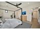 Comfortable bedroom with a four-poster bed, shiplap accent wall, black window frames, and a ceiling fan at 3964 E Penedes Dr, Gilbert, AZ 85298