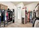 Well-organized walk-in closet with hanging rods and shelves for shoes, boxes, and clothes at 3964 E Penedes Dr, Gilbert, AZ 85298