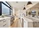 Modern white kitchen with stainless appliances and a large island featuring gray veining at 3964 E Penedes Dr, Gilbert, AZ 85298