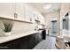 Laundry room with two-tone cabinets, a white countertop, and a patterned tile floor at 3964 E Penedes Dr, Gilbert, AZ 85298