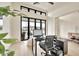 Stylish home office featuring hardwood floors, modern desk, and natural light from expansive windows at 3964 E Penedes Dr, Gilbert, AZ 85298