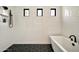 Modern shower with white subway tile walls, hexagon tile floor, a rain shower head, and black accents at 3964 E Penedes Dr, Gilbert, AZ 85298