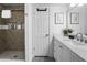 Stylish bathroom featuring a tiled walk-in shower, modern vanity, and sleek fixtures at 402 E Muriel Dr, Phoenix, AZ 85022