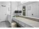 Bathroom featuring a marble vanity countertop, well-lit mirror, and a separate vanity area at 402 E Muriel Dr, Phoenix, AZ 85022