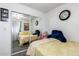 Bedroom with mirrored closet, gray carpet, and brick wall with a decorative clock at 4202 N 74Th Dr, Phoenix, AZ 85033