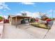 Single-story home featuring a large covered carport, fenced front yard, and convenient driveway access at 4202 N 74Th Dr, Phoenix, AZ 85033