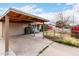 Single-story home featuring a large covered carport, fenced front yard, and convenient driveway access at 4202 N 74Th Dr, Phoenix, AZ 85033