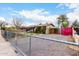 Street view of a single-story home with fencing, a covered carport, and mature trees at 4202 N 74Th Dr, Phoenix, AZ 85033