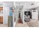 Bright hallway leads to a comfortable living area, showcasing tile flooring and seamless home flow at 4202 N 74Th Dr, Phoenix, AZ 85033