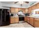 Cozy kitchen features classic wood cabinets, stainless steel appliances, and tile flooring at 4202 N 74Th Dr, Phoenix, AZ 85033