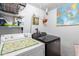 This laundry room includes a white washer and modern black dryer at 4202 N 74Th Dr, Phoenix, AZ 85033