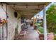 Covered patio with rocking chairs, a vintage car, and decorative accents at 4202 N 74Th Dr, Phoenix, AZ 85033