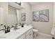 Modern bathroom featuring double sinks, a large mirror, and neutral decor at 42490 W Vincent Dr, Maricopa, AZ 85138