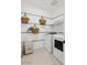 Laundry room with modern washer and dryer and decorative woven baskets at 42490 W Vincent Dr, Maricopa, AZ 85138