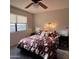 Cozy bedroom with natural light, ceiling fan, and black nightstands on either side of the bed at 425 S Parkcrest -- # 323, Mesa, AZ 85206