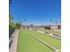 Exterior wide shot of manicured lawn bowling courts with benches under a blue sky at 425 S Parkcrest -- # 323, Mesa, AZ 85206