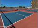 A brightly colored outdoor pickleball court fenced and ready for play on a sunny day at 425 S Parkcrest -- # 323, Mesa, AZ 85206