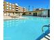 Exterior shot of a community pool surrounded by lounge chairs and palm trees on a bright day at 425 S Parkcrest -- # 323, Mesa, AZ 85206