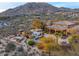 An aerial view captures the desert landscape of the property with a pool, spa, and covered gazebo in the backyard at 42613 N 111Th Pl, Scottsdale, AZ 85262