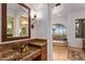 Well appointed primary bathroom featuring stone countertops and tub with scenic outdoor views at 42613 N 111Th Pl, Scottsdale, AZ 85262