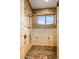 Custom tiled shower with mosaic accents and window with outdoor view at 42613 N 111Th Pl, Scottsdale, AZ 85262