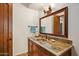 Charming powder room featuring a copper sink, granite countertop, and decorative mirror at 42613 N 111Th Pl, Scottsdale, AZ 85262