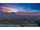 Panoramic view of a vibrant cityscape nestled against a backdrop of majestic mountains at sunset at 42613 N 111Th Pl, Scottsdale, AZ 85262