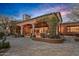 Exterior shot featuring outdoor living area and manicured landscape at sunset at 42613 N 111Th Pl, Scottsdale, AZ 85262