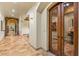 Elegant hallway features stone accents, arched doorways, and wine cellar access at 42613 N 111Th Pl, Scottsdale, AZ 85262