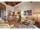 Spacious living room with a stone accent wall, wet bar and tiled flooring at 42613 N 111Th Pl, Scottsdale, AZ 85262