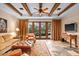 Open living room features tiled floors, beamed ceilings, and an abundance of natural light at 42613 N 111Th Pl, Scottsdale, AZ 85262