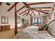 Elegant main bedroom featuring a beamed ceiling, fireplace, and outdoor views at 42613 N 111Th Pl, Scottsdale, AZ 85262