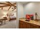 Lovely primary bedroom with exposed beam ceilings, connecting to an ensuite bathroom with a vanity at 42613 N 111Th Pl, Scottsdale, AZ 85262