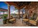 Covered patio with fireplace and comfortable seating area at 42613 N 111Th Pl, Scottsdale, AZ 85262