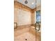 Beautifully tiled walk-in shower with glass door, bench and multiple shower heads at 42613 N 111Th Pl, Scottsdale, AZ 85262