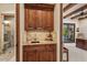 Convenient wet bar area leading to a bathroom with a shower and view of an adjacent bedroom at 42613 N 111Th Pl, Scottsdale, AZ 85262