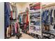 Well-organized walk-in closet with ample storage space for clothing and shoes at 4365 E Anderson Dr, Phoenix, AZ 85032