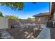 Low-maintenance backyard featuring gravel landscaping, a secure dog run and space for outdoor storage at 4503 E Elmwood St, Mesa, AZ 85205